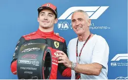  ?? Photos: AFP ?? Ferrari’s Monegasque driver Charles Leclerc celebrates after claiming pole position in the qualifying session for the Formula One Azerbaijan Grand Prix at the Baku City Circuit in Baku, Azerbaijan on June 11, 2022.