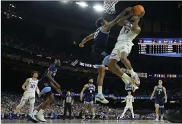  ?? DAVID J. PHILLIP — THE ASSOCIATED PRESS ?? Kansas' David McCormack, right, who scored 25 points, muscles his way to the basket to shoot over Villanova's Jermaine Samuels during the first half of a NCAA Tournament semifinal on Saturday in New Orleans. The Jayhawks rolled to a 81-65victory.