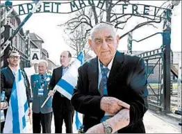  ?? JANEK SKARZYNSKI/GETTY-AFP ?? Zoltan Matyah, a survivor of the Auschwitz-Birkenau death camp, shows the number Nazis tattooed on his arm during a remembranc­e event Thursday in Oswiecim, Poland.