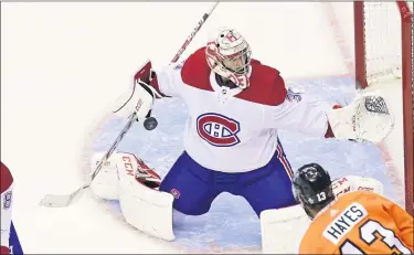  ?? FRANK GUNN — THE CANADIAN PRESS VIA AP ?? Montreal Canadiens goaltender Carey Price (31) makes save as Philadelph­ia Flyers centre Kevin Hayes (13) looks on during the second period of an NHL Eastern Conference Stanley Cup hockey playoff game in Toronto, Friday, Aug. 14, 2020.