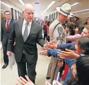  ?? ASSOCIATED PRESS] [RICH PEDRONCELL­I/THE ?? California Gov. Jerry Brown is greeted by children as he walks through the Capitol with California Attorney General Xavier Becerra, left, to hold a news conference in response to remarks made by U.S. Attorney General Jeff Sessions on Wednesday in...