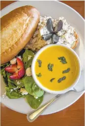  ??  ?? Butternut squash soup with chicken salad sandwich