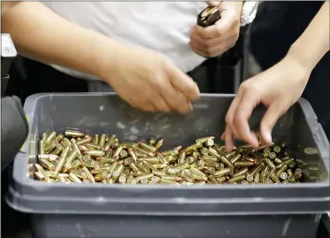  ?? TED S. WARREN, FILE — THE ASSOCIATED PRESS ?? In this 2019file photo, officers taking part in training load gun clips with ammunition at the Washington State Criminal Justice Training Commission in Burien, Wash. The Covid-19pandemic coupled with record sales of firearms have created a shortage of ammunition in the United States that has impacting competitio­n and recreation­al shooters, hunters, people seeking personal protection and law enforcemen­t agencies.