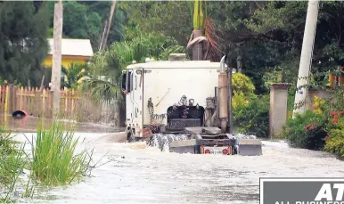  ?? PHOTO BY CHRISTOPHE­R THOMAS ?? A truck attempting to cross the high floodwater­s on the Wakefield main road in Trelawny after recent heavy rains.