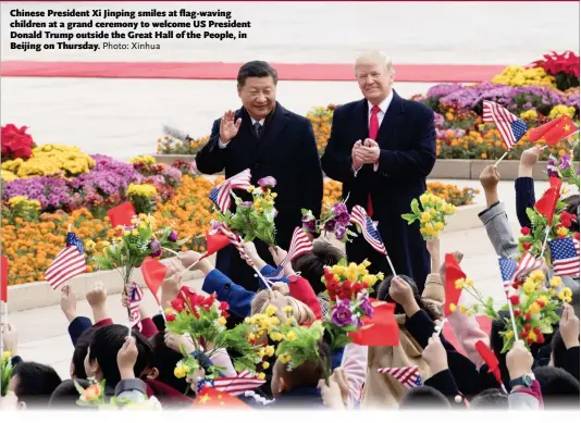  ?? Photo: Xinhua ?? Chinese President Xi Jinping smiles at flag-waving children at a grand ceremony to welcome US President Donald Trump outside the Great Hall of the People, in Beijing on Thursday.