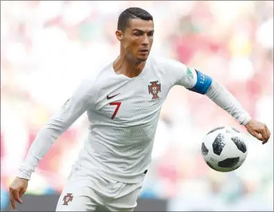  ?? The Associated Press ?? Portugal’s Cristiano Ronaldo goes for the ball during a Group B match against Morocco at the 2018 soccer World Cup in Moscow, Russia, on Wednesday. Portugal won 1-0.