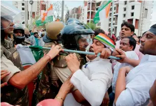  ?? AFP ?? Police clash with Congress Party workers as they take part in a demonstrat­ion calling for the resignatio­n of the chief minister of Madhya Pradesh in Bhopal on Saturday. —