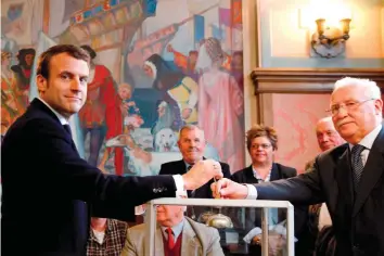  ?? — AFP ?? French presidenti­al election candidate for the En Marche! movement Emmanuel Macron casts his ballot at a polling station in Le Touquet, northern France, during the second round of the French presidenti­al election.