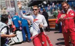 ?? —AFP ?? MONACO: Ferrari’s German driver Sebastian Vettel acknowledg­es the audience after winning the third practice session at the Monaco street circuit, yesterday in Monaco, a day ahead of the Monaco Formula 1 Grand Prix.
