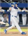  ?? MATT STAMEY/ASSOCIATED PRESS ?? Austin Langworthy drives his walk-off home run that kept alive UF’s national title defense hopes.