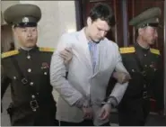  ?? JON CHOL JIN — THE ASSOCIATED PRESS FILE ?? American student Otto Warmbier, center, is escorted at the Supreme Court in Pyongyang, North Korea. Warmbier, an American college student who was released by North Korea in a coma last week after almost a year and a half in captivity, died Monday, June...
