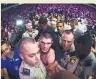  ??  ?? BRAWL OVER Khabib is escorted out of the arena