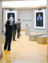  ??  ?? Visitors watch virtual versions of Holocaust survivors Eva Schloss and Pinchas Gutter at the New Dimensions in Testimony exhibit,