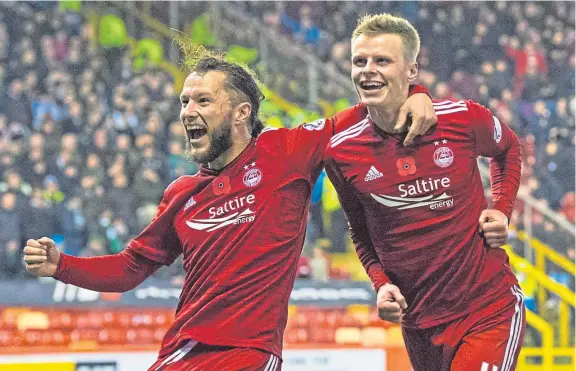  ?? Picture: SNS. ?? Gary Mackay-Steven, right, celebrates with Stevie May after scoring the winner for Aberdeen in a 1-0 victory over Hibernian at Pittodrie last night. See theSport.
