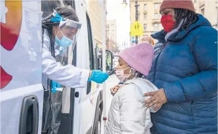  ?? DAVE SANDERS/THE NEW YORK TIMES ?? A child is tested at a mobile testing site Thursday in the Brooklyn borough of New York.