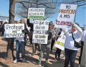  ?? ?? People flash signs at a car that honked as they walked on Lincoln Boulevard during a rally and walk to the Capitol by Oklahoma Providers for Privacy to remove mental health from the Health Informatio­n Exchange mandate, Saturday.