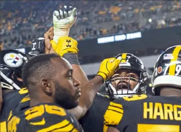  ?? Steph Chambers/Post-Gazette ?? Defensive end Cameron Heyward, second from right, shouts to teammates in Thursday’s win over Carolina at Heinz Field. The Steelers are in a good position after Sunday’s results.