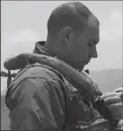  ?? U.S. MARINE CORPS FILE PHOTOGRAPH ?? Marine Corps Capt. Jameson Hustek, an MV22B Osprey pilot, puts on his gear before participat­ing in a search and rescue exercise near Naval Auxiliary Landing Field San Clemente Island in 2014.