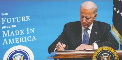  ?? DREW ANGERER/GETTY IMAGES ?? U.S. President Joe Biden signs a Buy American executive order on Monday in Washington, D.C. Canadian businesses are expected to find it more challengin­g to secure contracts in the United States under the tougher rules that boost American businesses.