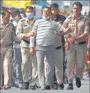  ?? PTI ?? Vikas Dubey is taken into custody by the Madhya Pradesh police in Ujjain on Thursday.