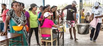  ??  ?? FOOD distributi­on in Venezuela.