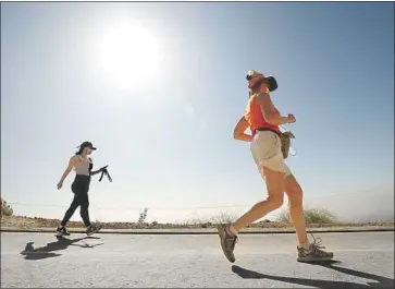  ?? Al Seib Los Angeles Times ?? HIKERS on Wednesday at Runyon Canyon, which has installed cameras and put in place a one-way loop.