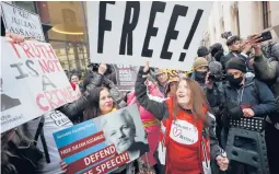  ?? FRANKAUGST­EIN/AP ?? Supporters of WikiLeaks founder Julian Assange celebrate in London after a ruling Monday that he cannot be extradited to the United States.