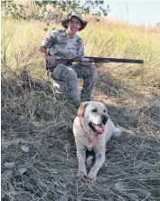  ??  ?? Garrett Kyle of Yukon and his dog, Sage, wait for some doves to fly by last year while hunting near Beaver.