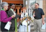  ?? PHOTOS BY CHRISTINE WOLKIN — FOR DIGITAL FIRST MEDIA ?? Attending the vigil Sunday are, from left, Bishop Peggy Johnson, Philadelph­ia Episcopal Area, UMC; Pastor Christophe­r Kurien, Lansdale UMC; the Rev. Dr. Deborah Darlington of The Space for Grace; and the Rev. Paul Lutz of Trinity Lutheran Church.