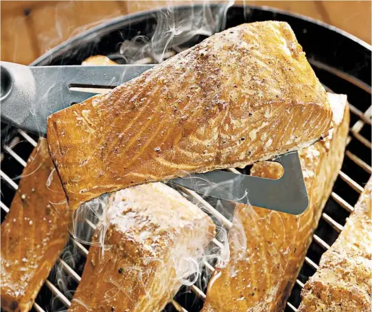  ?? MICHAEL TERCHA/CHICAGO TRIBUNE; MARK GRAHAM/FOOD STYLING ?? Fish smoked on a grill retains its moistness. Because grill smoking doesn’t preserve the fish the way cold smoking does, it should be enjoyed right away.