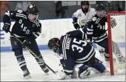  ?? DAVID DALTON — FOR MEDIANEWS GROUP ?? Dakota goalie Jeffrey Buckley reaches down to stop the puck during a MAC Red game against Eisenhower Monday. Buckley did not allow a goal as the Cougars won, 1-0.