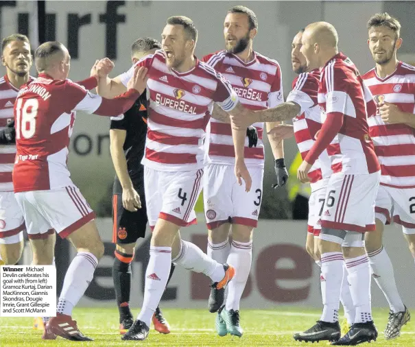  ??  ?? Winner Michael Devlin celebrates his goal with (from left) Gramoz Kurtaj, Darian Mackinnon, Giannis Skondras, Dougie Imrie, Grant Gillespie and Scott Mcmann