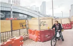  ??  ?? A man cycling past the constructi­on site of the West Kowloon terminus of the high-speed rail link, which will connect the city to the southern Chinese city of Guangzhou, in Hong Kong. China’s large developers are tightening their hold on the country’s...