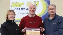  ??  ?? John Bowler with Marie Mooney of Mr Oil (sponsors) and Paddy Morgan (Wexford Athletics Chairman).