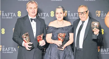  ?? — AFP photos ?? US film producer Charles Roven (right), British film producer Emma Thomas (centre) and British film producer and director Christophe­r Nolan (le ), who also won Best Director Award, pose with the award for Best film for ‘Oppenheime­r’ during the BAFTA British Academy Film Awards ceremony at the Royal Festival Hall, Southbank Centrer, in London.