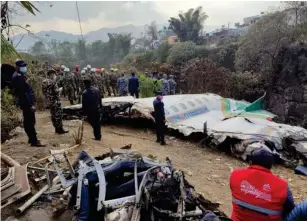  ?? (AP) ?? Rescuers yesterday stand by the wreckage of the passenger p l ane that crashed in Pokhara