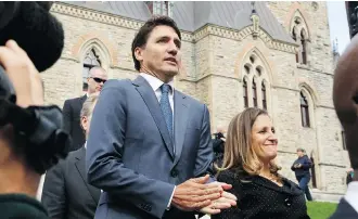  ?? PATRICK DOYLE/AFP/GETTY IMAGES ?? Prime Minister Justin Trudeau and Minister of Foreign Affairs Chrystia Freeland walk to a press conference to announce the new USMCA trade pact in Ottawa, Monday.