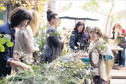  ?? Photograph­s by Jess Isaac ?? WITH ALL the fresh greens and f lorals, few parties smell better than a wreath-making get-together. Kids can participat­e too.