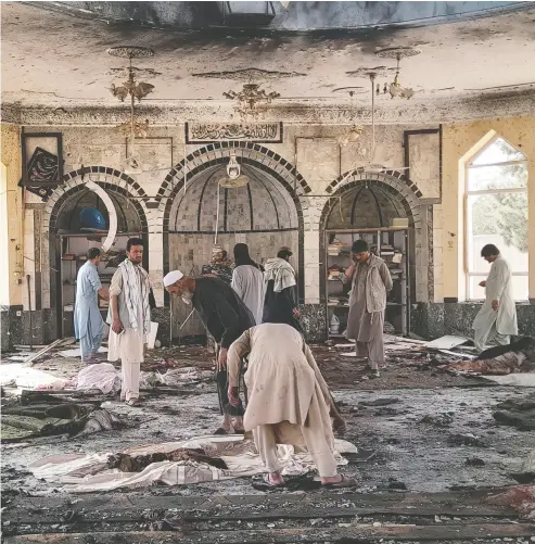  ?? ABDULLAH SAHIL / THE ASSOCIATED PRESS ?? People view the damage inside of a mosque Friday following a bombing in Kunduz, a province in northern Afghanista­n. The powerful explosion has left several casualties, witnesses and the Taliban’s spokesman said.