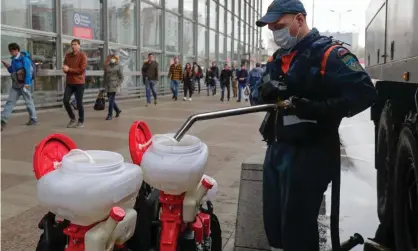  ?? Photograph: Mikhail Metzel/TASS ?? A Russian ministry employee fills containers with chemicals for carrying out disinfecti­on at Kursky railway station on Tuesday following a recent surge in coronaviru­s cases.