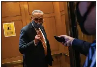  ?? (The New York Times/Samuel Corum) ?? Senate Minority Leader Charles Schumer (left photo) leaves the Senate floor Wednesday after a GOP stimulus bill was voted down in what Schumer called a political stunt that was designed to fail.