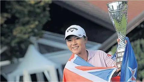  ?? AFP ?? Lydia Ko celebrates with the New Zealand national flag and her trophy after winning the Evian Championsh­ip.