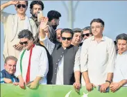  ?? ?? Pakistan’s ousted prime minister Imran Khan (centre) waves at his supporters during a rally in Islamabad on May 26.
