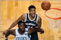  ??  ?? File, Charles Krupa / AP
Boston’s Semi Ojeleye (left) blocks out Milwaukee’s Giannis Antetokoun­mpo as they wait for a rebound during Game 7 of the first-round playoff series in Boston.