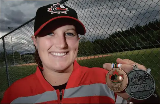  ?? CITIZEN PHOTO BY JAMES DOYLE ?? Amanda Asay in 2012 holds her silver medal from the Canadian national baseball championsh­ip and bronze medal from the Women’s Baseball World Cup. She died last Friday in a skiing accident near Nelson at the age of 33.