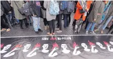  ?? GREGORIO BORGIA/ASSOCIATED PRESS ?? Women take part in a march marking the Internatio­nal Day for the Eliminatio­n of Violence against Women, in Rome on Saturday.