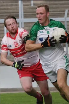  ??  ?? Matthew O’Hanlon of St. James’ is tackled by Kilanerin’s Peter Hughes.