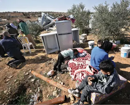  ?? AP ?? A Palestinia­n family is rendered homeless following the demolition of their home by Israeli authoritie­s at Khirbet Ma’in, south of Hebron, occupied West Bank.