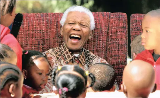  ?? Picture: DENIS FARRELL / AP ?? UNIFIER: Nelson Mandela laughs while celebratin­g his birthday with beneficiar­ies of the Nelson Mandela Children’s Fund in Johannesbu­rg.