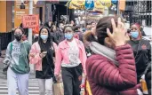  ?? STEPHANIE KEITH/THE NEW YORK TIMES ?? Pedestrian­s at Times Square in Manhattan on May 2.